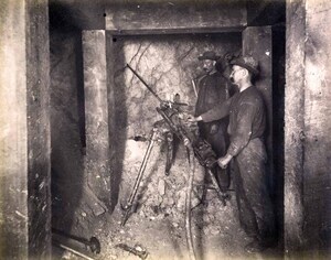 High ore 300 ft. level East Showing tripod and drilling machine in operation